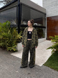 DAXUEN camouflage sweatpants with bold swirling graphics — model photo