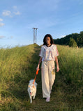 DAXUEN light beige wide-leg trousers with bold text graphic — model photo