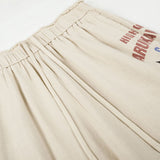 DAXUEN light beige wide-leg trousers with bold text graphic