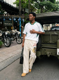 DAXUEN light beige wide-leg trousers with bold text graphic — model photo