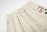 DAXUEN light beige wide-leg trousers with bold text graphic