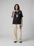 DAXUEN light beige wide-leg trousers with bold text graphic — model photo