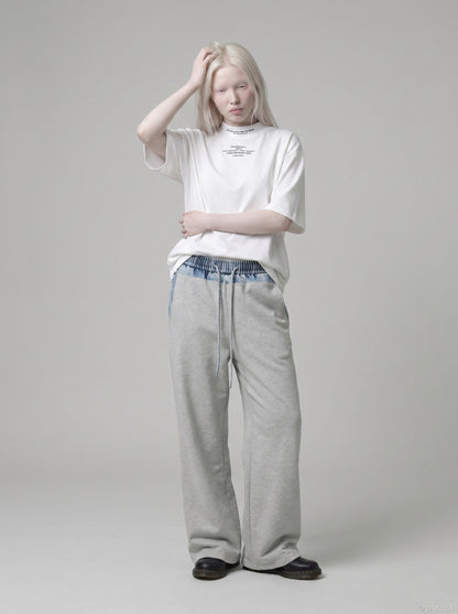 DAXUEN white oversized text graphic mock neck t-shirt — model photo