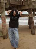 DAXUEN black oversized triangular graphic tee — model photo