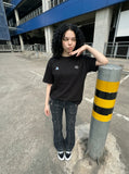 DAXUEN black oversized triangular graphic tee — model photo