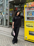 DAXUEN black oversized triangular graphic tee — model photo