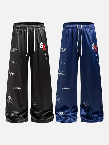 DAXUEN black satin wide-leg pants with bold two-letter graphic