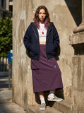 DAXUEN Midi-length skirt with utility pocket and zipper details — model photo