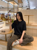 DAXUEN black vertical ribbed henley knit top — model photo