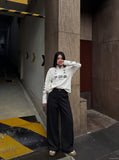 DAXUEN black bold graphic mock neck pullover top — model photo