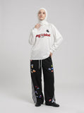 DAXUEN white long-sleeve polo shirt with bold wordmark and shield graphic — model photo