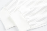 DAXUEN white long-sleeve polo shirt with bold wordmark and shield graphic
