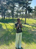 DAXUEN Camo graphic t-shirt with bold text and designs — model photo