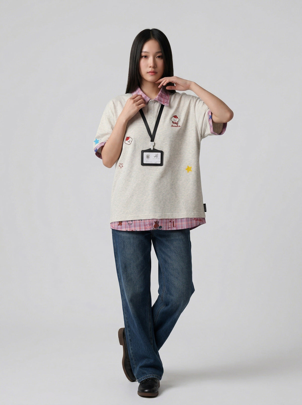 DAXUEN Layered polo shirt with cartoon graphics and plaid accents — model photo