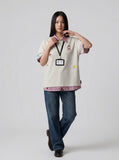 DAXUEN Layered polo shirt with cartoon graphics and plaid accents — model photo