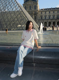 DAXUEN Layered polo shirt with cartoon graphics and plaid accents — model photo