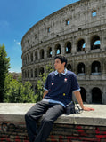 DAXUEN Layered polo shirt with cartoon graphics and plaid accents — model photo