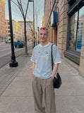 DAXUEN light blue cartoonish eternally embroidered henley tee — model photo