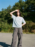 DAXUEN light blue cartoonish eternally embroidered henley tee — model photo