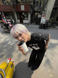 DAXUEN Oversized T-shirt with cat graphic and polka dot sleeves — model photo