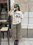 DAXUEN Light cream graphic T-shirt with chaotic print — model photo