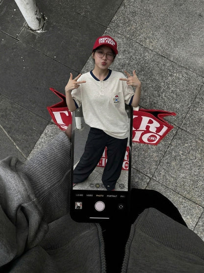 DAXUEN Short-sleeved henley-style T-shirt with graphic pocket — model photo