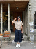 DAXUEN Short sleeve knitted polo shirt in black and light beige — model photo