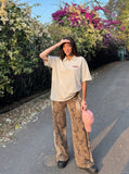 DAXUEN Light grey oversized polo shirt with red embroidery — model photo