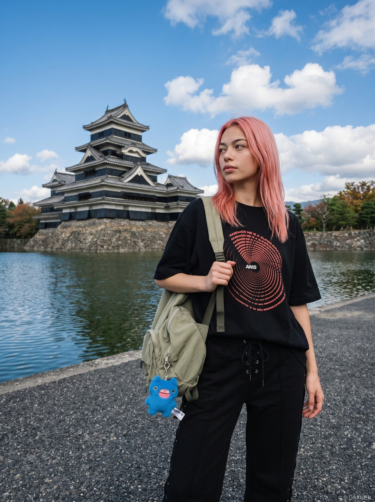 DAXUEN black oversized circular red text graphic tee — model photo