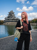 DAXUEN black oversized circular red text graphic tee — model photo