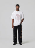 DAXUEN black oversized circular red text graphic tee — model photo