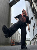 DAXUEN black oversized circular red text graphic tee — model photo
