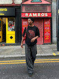 DAXUEN black oversized circular red text graphic tee — model photo