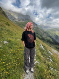 DAXUEN black oversized circular red text graphic tee — model photo