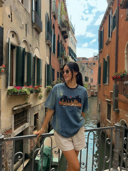 DAXUEN Embroidered denim t-shirt with cityscape design — model photo