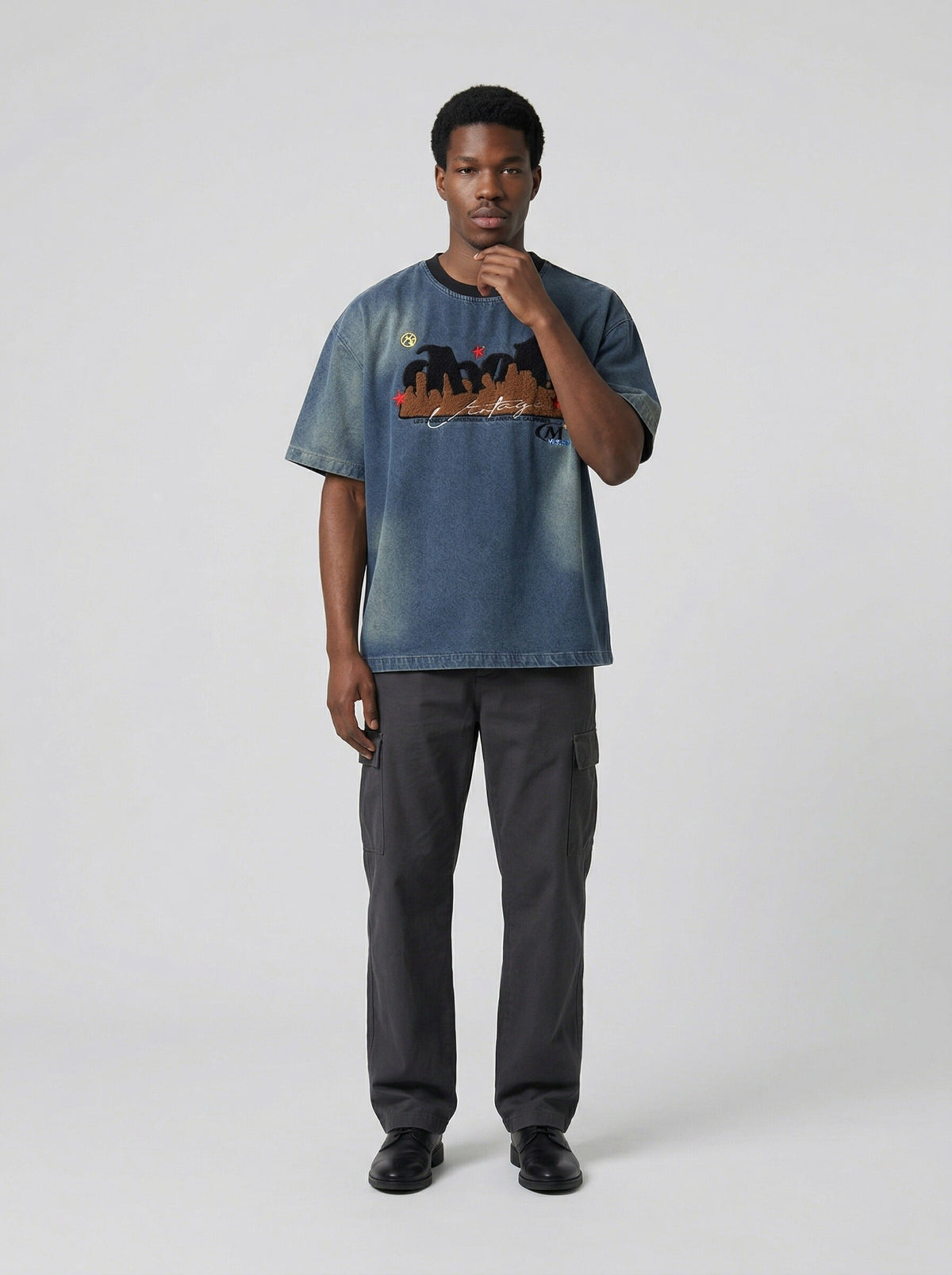 DAXUEN Embroidered denim t-shirt with cityscape design — model photo