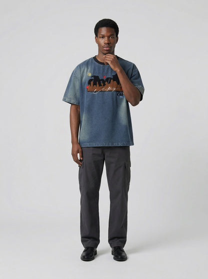 DAXUEN Embroidered denim t-shirt with cityscape design — model photo