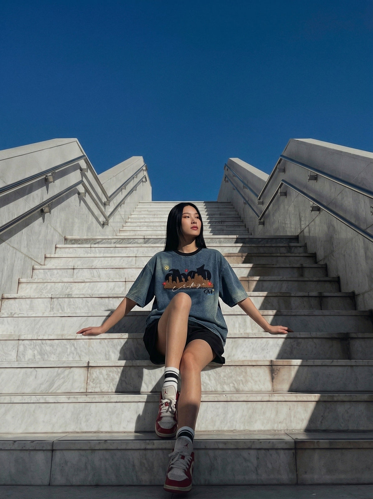 DAXUEN Embroidered denim t-shirt with cityscape design — model photo