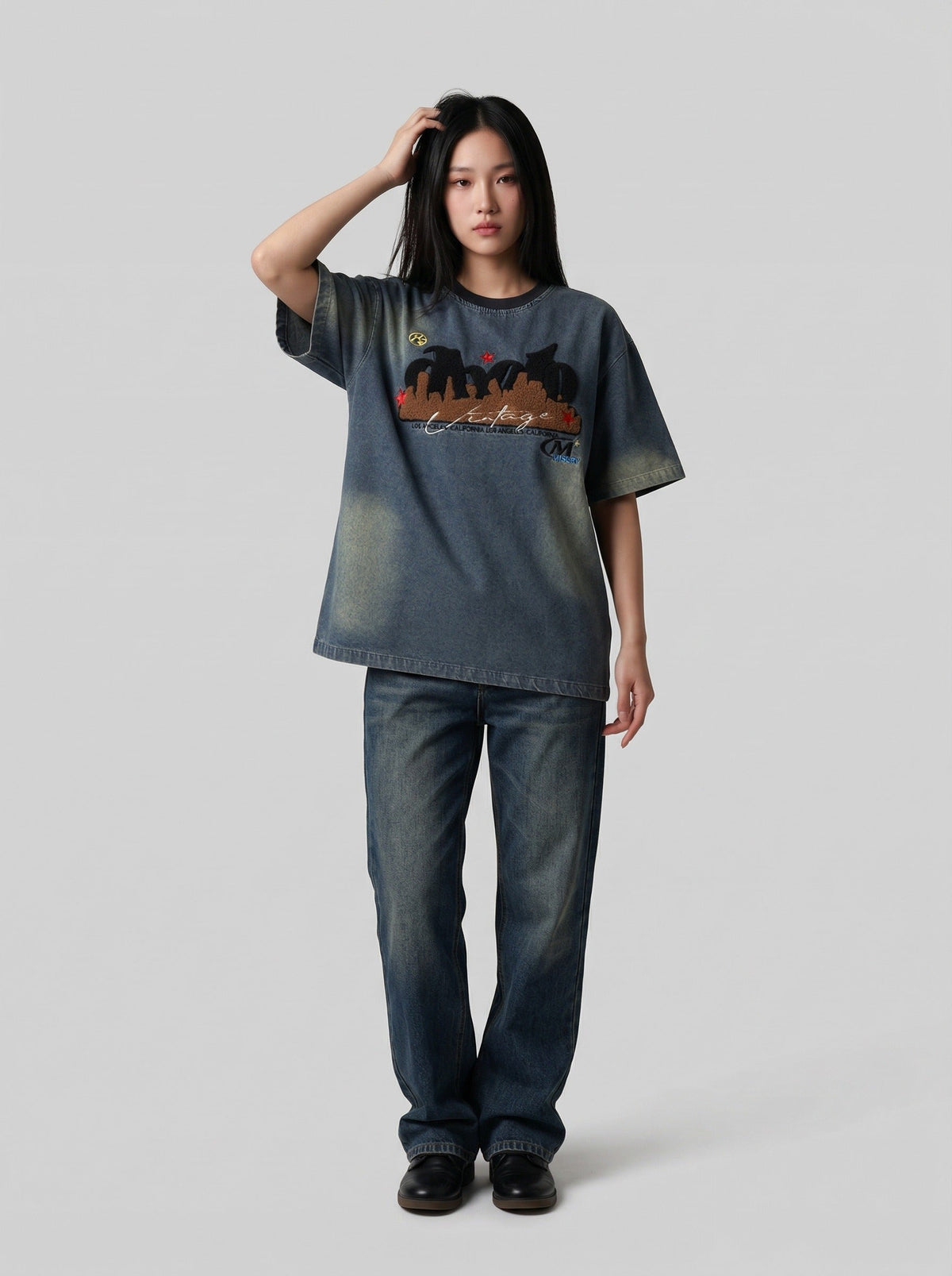 DAXUEN Embroidered denim t-shirt with cityscape design — model photo