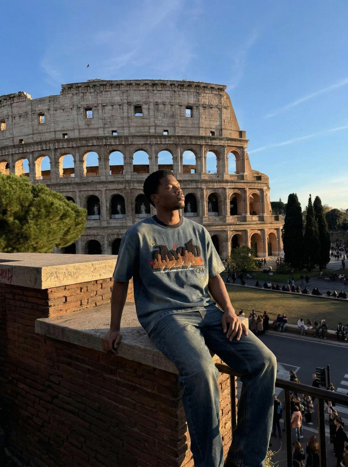 DAXUEN Embroidered denim t-shirt with cityscape design — model photo