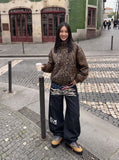 DAXUEN dark blue oversized claw mark distressed denim pants — model photo