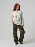 DAXUEN Distressed color-blocked long-sleeve top with graphic print — model photo