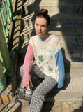 DAXUEN Distressed color-blocked long-sleeve top with graphic print — model photo