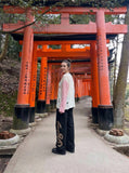 DAXUEN Distressed color-blocked long-sleeve top with graphic print — model photo