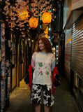 DAXUEN Distressed color-blocked long-sleeve top with graphic print — model photo