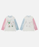 DAXUEN Distressed color-blocked long-sleeve top with graphic print
