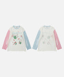 DAXUEN Distressed color-blocked long-sleeve top with graphic print