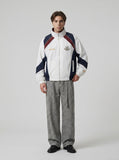 DAXUEN color-blocked track jacket with crest logo — model photo