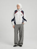 DAXUEN color-blocked track jacket with crest logo — model photo