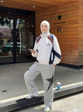 DAXUEN color-blocked track jacket with crest logo — model photo